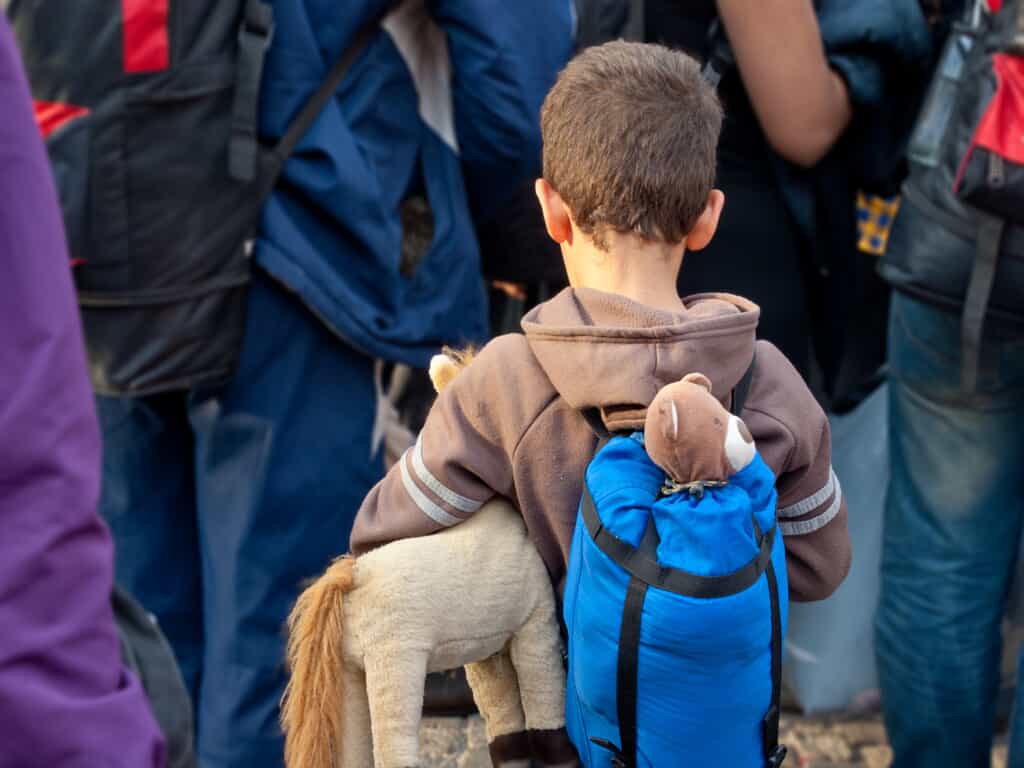 Child with Stuffed Bear & Horse Toys