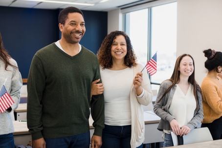 A smiling married couple completes the marriage-based green card process at USCIS.