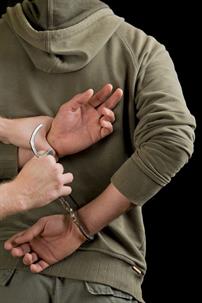 Man getting arrested by law enforcement.