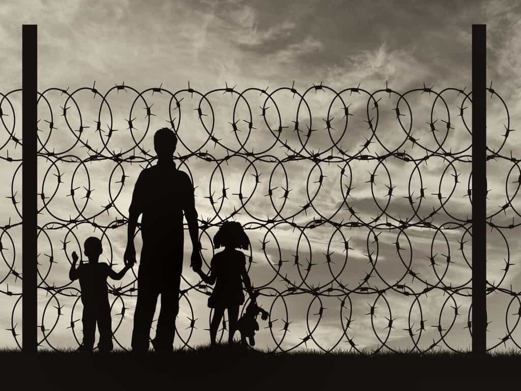 Family Near Barbed Wire Fence